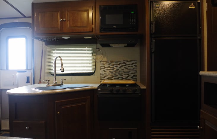 Double bowl sink, gas stove microwave, fridge.