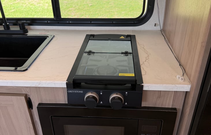 Your home kitchen on wheels, complete with a complimentary coffee maker, cookware, and utensils.