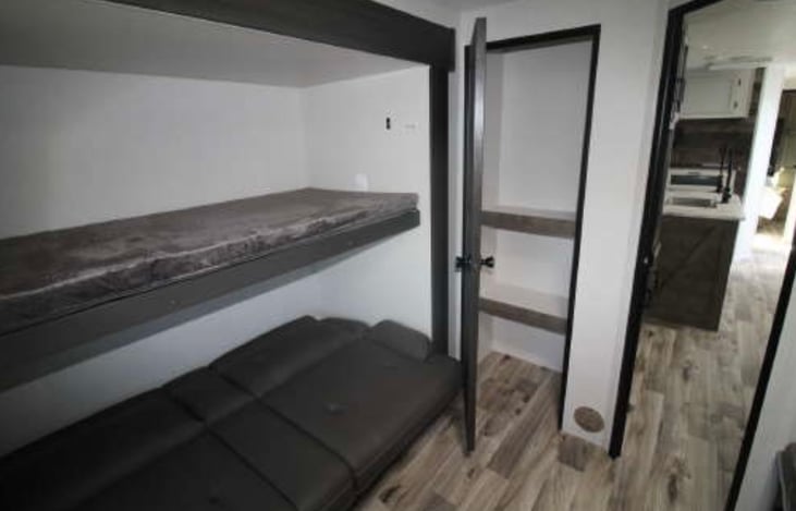 2nd bedroom bunk bed and fold down couch that makes into a full size bed.  Sheets, blanket and pillows provided.