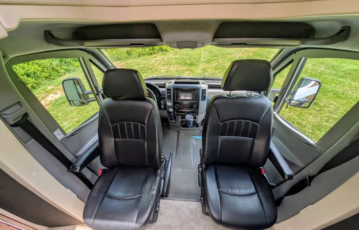 Comfortable Mercedes cabin with swing-around captain's chairs.