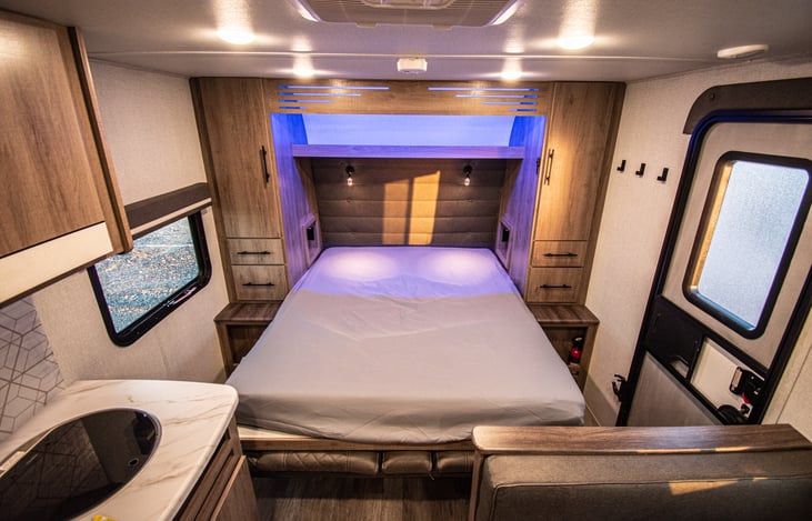 Queen size bed with overhead lighting and personal book lights, per side.