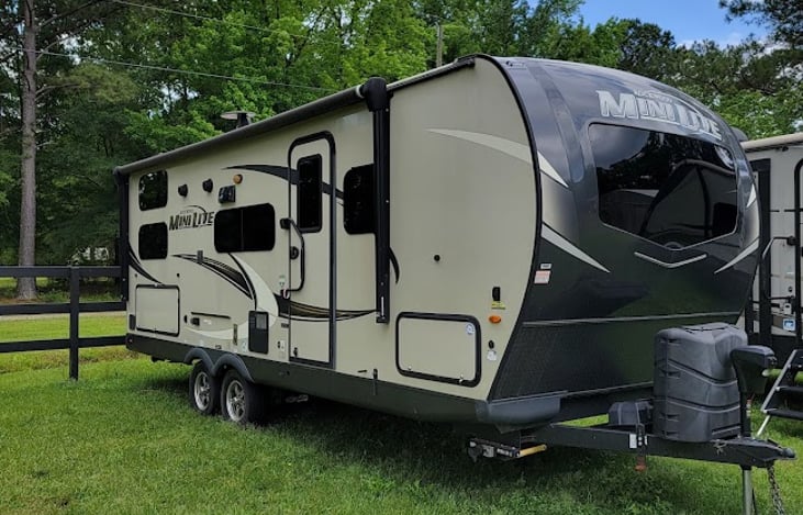 Camp side with large lighted awning, outdoor tv mount, built-in speakers and outlets.