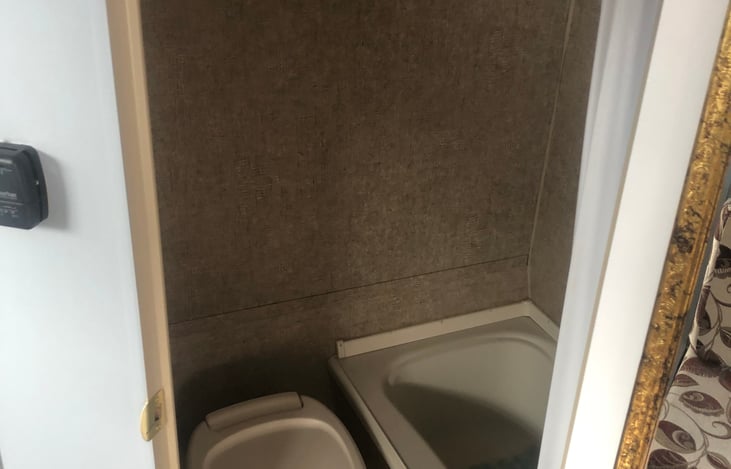 Bathroom with tub shower and toilet