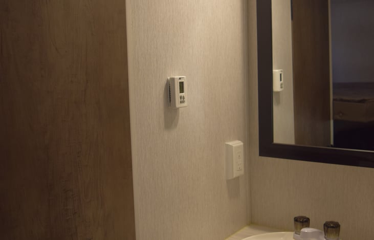 Bathroom sink located outside of the bathroom to give more room.