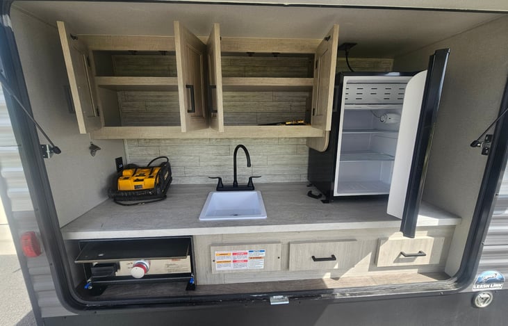 Fully equipped outdoor kitchen for convenient camp side cooking and meal prep.