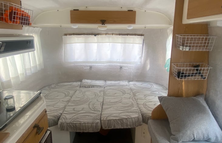 Casita interior dinette/convertible bed view. Just take the post down, set the table on the booth, move cushions down, and use provided linens to set up your sleep area.