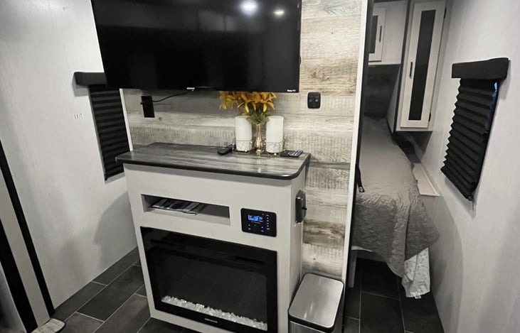 Behind the fireplace is the king bedroom with sliding door doors on either side.