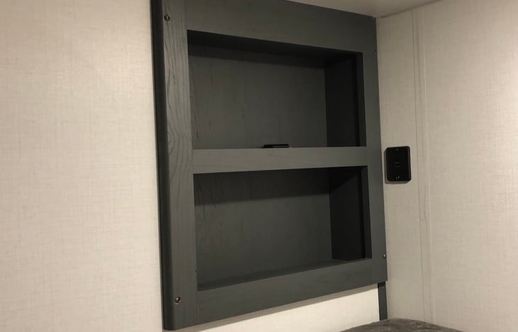 Cubby holes and charging station for the top bunk.