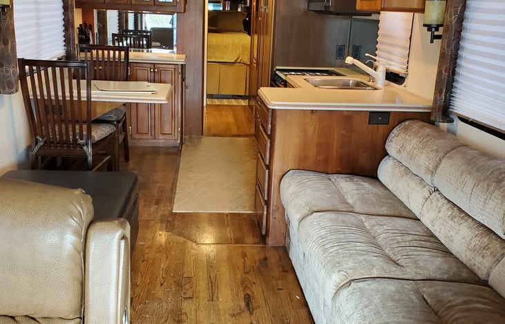 Micro fiber couch which opens into a bed.
Wood floors
All high end cherry cabinets
Solid surface countertops.