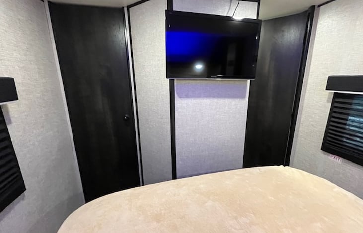 TV in master bedroom. Also a full closet for additional storage.