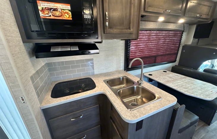 Convection microwave, two burner stove, and double basin sink allow you to feed the gang.