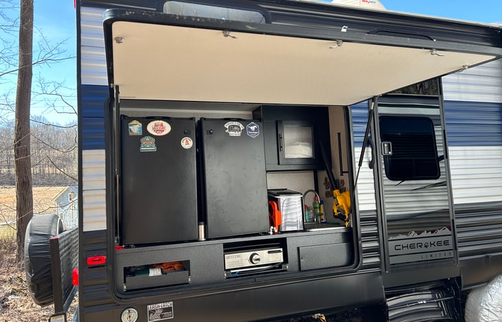 Outdoor kitchen featuring 2 refrigerators, and ice maker and storage