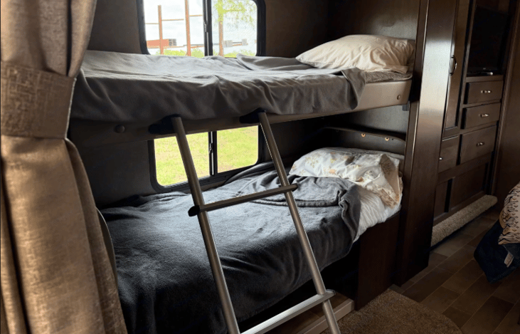 Bunk bed area : folded down top bunk and table converted to bottom bunk