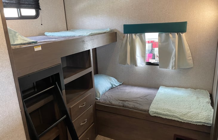 Two Twin sized bunks with ladder, three drawers for storage.