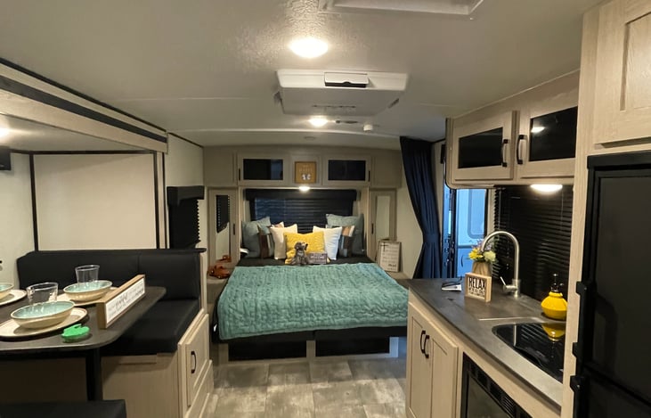 Full galley kitchen, a large fridge that runs on electricity or propane, tons of lighting and comfortable spaces to enjoy your camping Adventure.