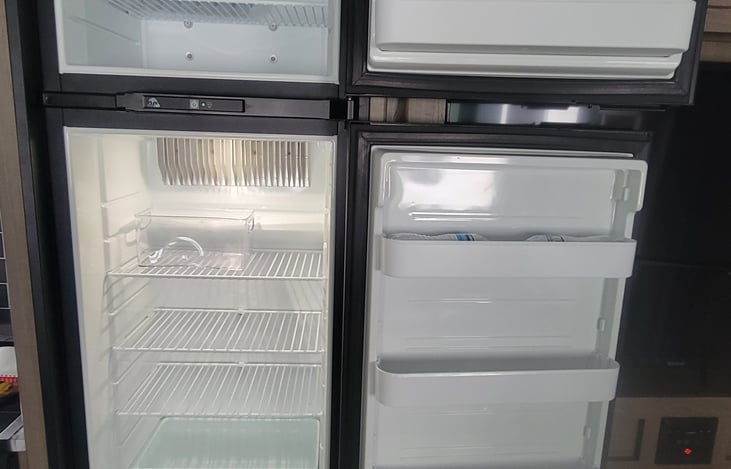 Single fridge and freezer with ice tray provided.