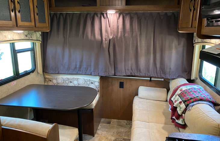 Looking toward the front, the trifold sofa lifts up for storage access and folds out to allow a small person to sleep.  The dining area also converts to allow a small person to sleep.