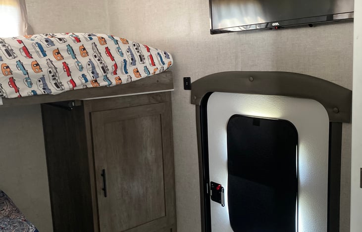 T.V in the spare room with the exit door blocked off with a cover to keep the sun/heat out as well as feeling you have more privacy.