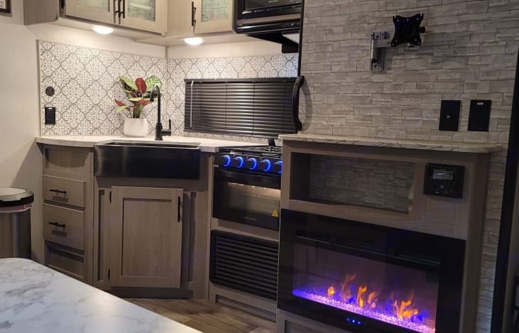 Kitchen area with the electric fireplace going.