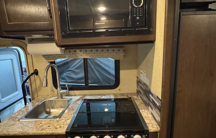 Microwave, stovetop, oven. Full size sink with pull down faucet head for easy cleaning.