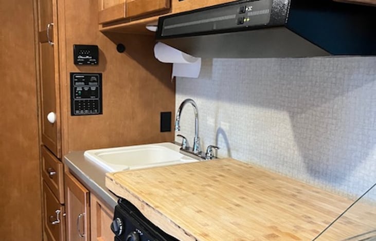 Kitchen with sink, stove, oven and microwave