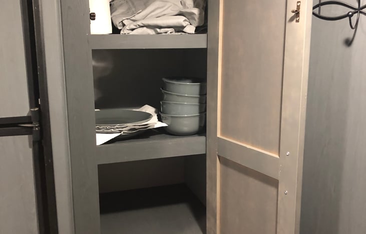 Plenty of storage in the pantry. Also plates and bowls for four.