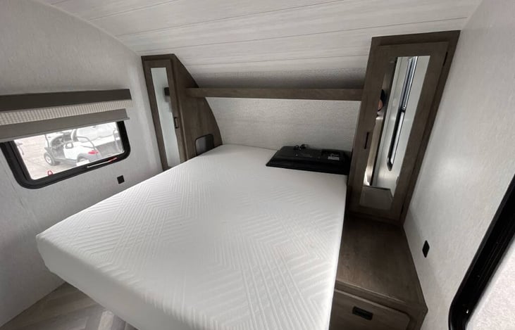 Main bedroom in front of camper with Queen short mattress