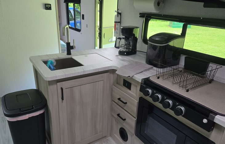 Coffee pot, counter top ice maker, full sized trash can