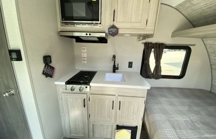 Kitchen has two burners, microwave and refrigerator (see other photo).  All plates, pans, silverware etc. provided.