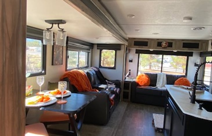 Overview of living and dining space and panoramic  views.  Smoke / CO detector above kitchen island.  Fire extinguisher at entry door below.