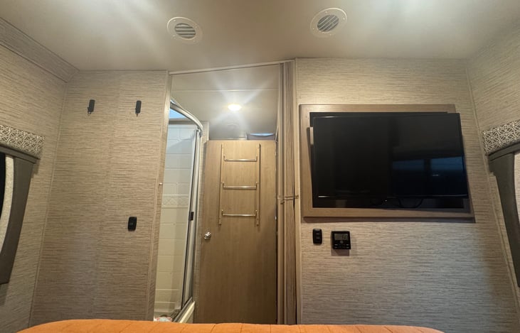 Bathroom door swings open to lock in place for privacy. TV in rear bedroom.
