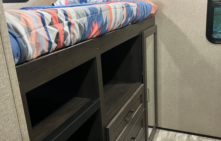 Full-size bed over the closet, 4 storage nooks (which doubles as the ladder), and drawers