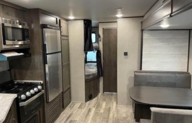 View from master bedroom.  Bunk beds are located in back left and both have a privacy curtain and USB ports to charge electronic devices.