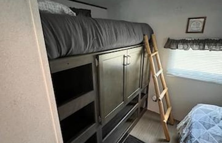 Rear bunk area with twin bed, storage underneath. And Full bed, or you can put the full bed up and you have an office desk.