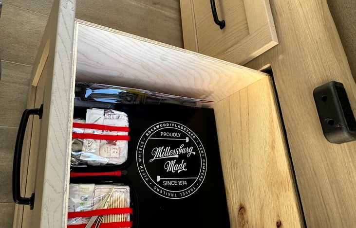 First aid kit, owners Manuel, and spatula are located in this drawer