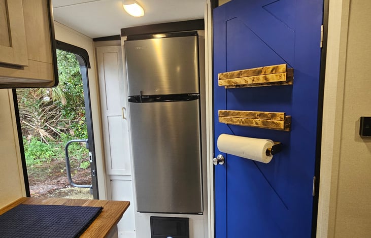 Bold blue barn door with custom wood accents — thoughtful touches throughout