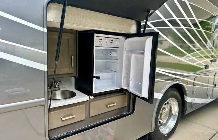 Unique for a motorhome to have an outdoor fridge + sink.