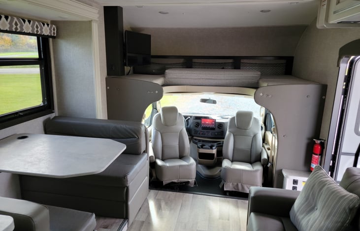 Front queen bed + LED HD Smart Fire TV in living area + Swivel driver and passenger seats