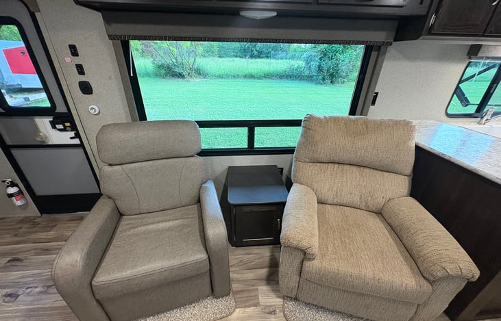 Both chairs fully recline. The chair on the right is the best seat in the house, so make sure you call dibs...