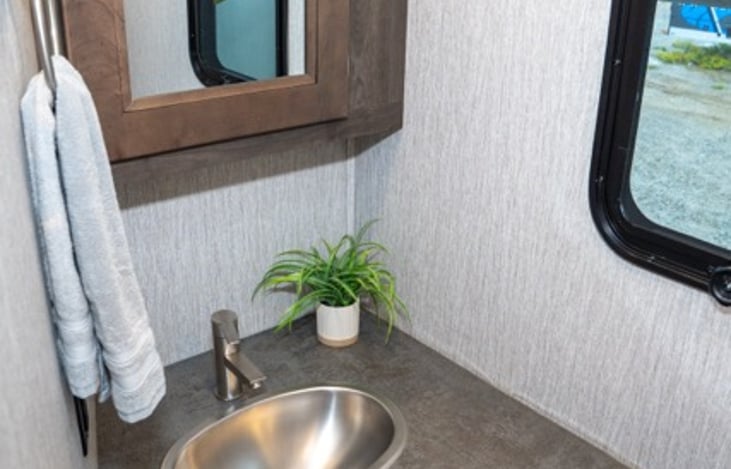 powder bath is the perfect place for kids or guests to use the facilities without going through the primary bedroom.  Large vanity and toilet stocked with toilet paper and hand soap.