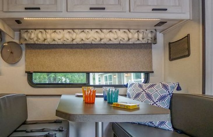 Dinette has 2 safety belts. USB charging station and wall net under cabinet. Both benches has roomy drawers for our pots and pans, vacuum and broom set.