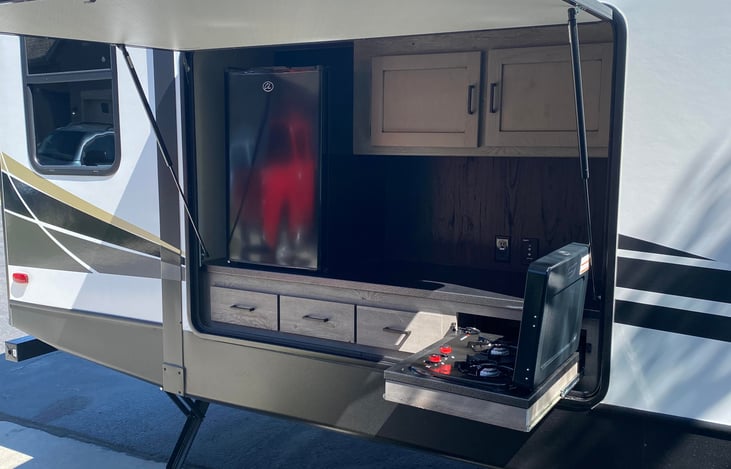 outdoor camp stove and large electric refrigerator.