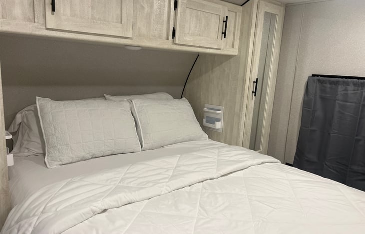 Queen bed with four pillows