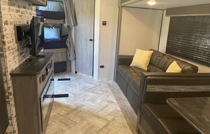 Bunks with the bathroom on the right. Couch with the TV