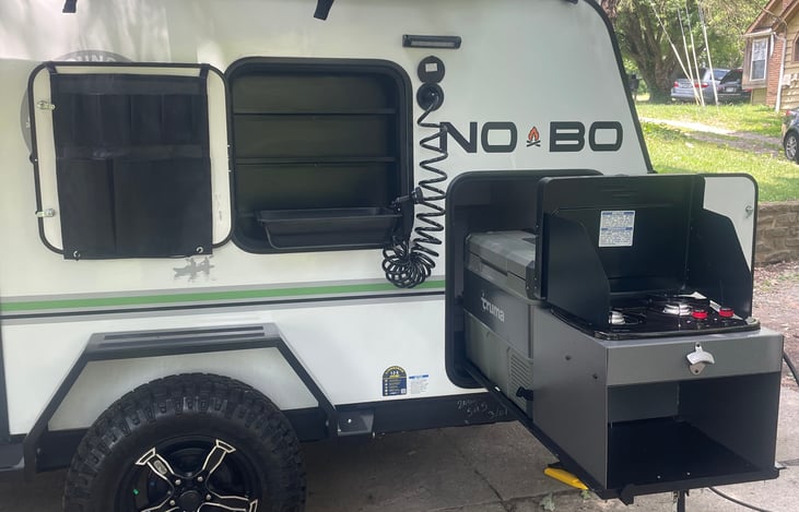 Pull out kitchen area. With two top propane burner, fridge and water hook up.