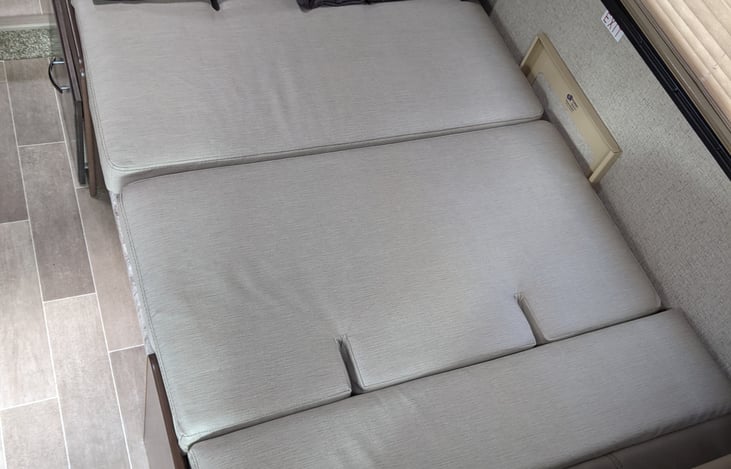 The table lowers into a bed. Comfortable? debatable but the younger you are the less you care. :)