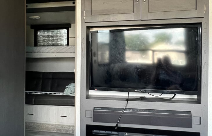 TV above fireplace.
On the left, the door is open to the bunkhouse.