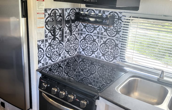 RV cooktop/stove.  Custom spice rack and magnetic knife rack and backsplash