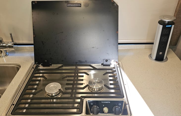 Dual burner cook top and pop up power with 110v and USB.