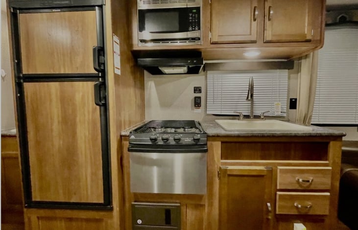 Large refrigerator and freezer. 4-burner gas stove and oven. Microwave (on shore power only) & large sink.